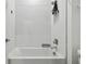 Clean, white bathroom featuring a tiled shower and a convenient shelf at 9802 Carabiner Way, Land O Lakes, FL 34637