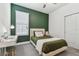 Cozy bedroom featuring an accent wall, desk by the window, and plush carpeting at 9802 Carabiner Way, Land O Lakes, FL 34637