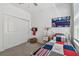 Comfortable bedroom with a playful baseball theme and window at 9802 Carabiner Way, Land O Lakes, FL 34637