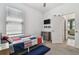 Comfortable bedroom with large window, mounted television, and doorway at 9802 Carabiner Way, Land O Lakes, FL 34637