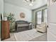 Adorable Bedroom featuring a gray crib, accent rug, and comfortable armchair with plenty of natural light at 9802 Carabiner Way, Land O Lakes, FL 34637