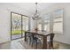 Dining room showcasing a wood table and access to the backyard at 9802 Carabiner Way, Land O Lakes, FL 34637
