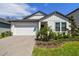 Charming single-Gathering home with a two-car garage and brick-paved driveway at 9802 Carabiner Way, Land O Lakes, FL 34637