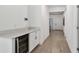 Hallway with wood-look floors, leading to the entrance, with a beverage cooler on the left at 9802 Carabiner Way, Land O Lakes, FL 34637