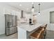 Bright kitchen with an oversized island, stainless appliances, and modern pendant lighting at 9802 Carabiner Way, Land O Lakes, FL 34637