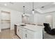 Modern kitchen featuring quartz countertops, stainless steel appliances and hanging pendant lights at 9802 Carabiner Way, Land O Lakes, FL 34637