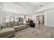 An open concept living room and kitchen with recessed lighting and plenty of natural lighting at 9802 Carabiner Way, Land O Lakes, FL 34637