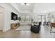 An open concept living room with natural lighting, recessed lighting, and an adjacent dining area at 9802 Carabiner Way, Land O Lakes, FL 34637