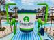 The community Splash Pad features a large water bucket, slides, and splash-friendly ground cover at 9802 Carabiner Way, Land O Lakes, FL 34637