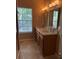 Bathroom featuring a double sink vanity, tile flooring, and a large window at 10002 Bradwell Pl, Tampa, FL 33626