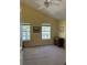 Spacious bedroom with vaulted ceilings, two windows, and neutral carpet flooring at 10002 Bradwell Pl, Tampa, FL 33626