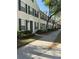 Charming townhome with green shutters and door, complemented by mature landscaping at 10002 Bradwell Pl, Tampa, FL 33626