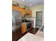Modern kitchen featuring stainless steel appliances, wooden cabinetry, and sleek countertops for culinary enthusiasts at 10002 Bradwell Pl, Tampa, FL 33626