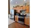 Modern kitchen with stainless steel appliances, stylish cabinetry, and ample counter space; perfect for cooking at 10002 Bradwell Pl, Tampa, FL 33626