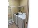 Efficient laundry room with modern Samsung washer and dryer plus metal storage shelves at 10002 Bradwell Pl, Tampa, FL 33626