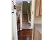 Carpeted staircase with a chairlift, wooden banister, and views of the surrounding rooms at 10002 Bradwell Pl, Tampa, FL 33626