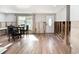 Light-filled living space with wood flooring, a dining set, and a white front door, ready for personalized upgrades at 103 W North Branch Rd, Ruskin, FL 33570