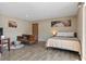 Bedroom features tile floors, a brown leather couch, and light tan walls at 1055 82Nd N Ter # 1055A, St Petersburg, FL 33702