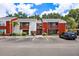 Exterior shot of a two-story condo with red brick and a black car parked in the parking lot at 1055 82Nd N Ter # 1055A, St Petersburg, FL 33702