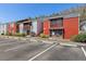 Red brick two-story condo building with a parking lot and well-maintained landscaping on a bright, sunny day at 1055 82Nd N Ter # 1055A, St Petersburg, FL 33702