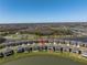Aerial view of a home and backyard overlooking a pond, a lake, and green spaces at 10934 Sundrift Dr, Tampa, FL 33647