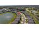 Aerial view of a home and backyard overlooking a lake and green spaces at 10934 Sundrift Dr, Tampa, FL 33647