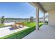 A backyard features a patio with a dining set, a playset, and a view of the lake at 10934 Sundrift Dr, Tampa, FL 33647