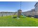A backyard features a playset with a swing and slide at 10934 Sundrift Dr, Tampa, FL 33647