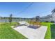 A backyard features a patio with a dining set and lake views at 10934 Sundrift Dr, Tampa, FL 33647