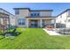 The backyard features a patio with outdoor seating, a playset, and lush green grass at 10934 Sundrift Dr, Tampa, FL 33647