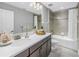 Bathroom with modern vanity, large mirror, and tiled shower at 10934 Sundrift Dr, Tampa, FL 33647