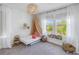 Bright bedroom featuring a window, decorative canopy, and charming decor at 10934 Sundrift Dr, Tampa, FL 33647