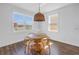 A dining area with a round table, wooden chairs, and natural light streaming through large windows at 10934 Sundrift Dr, Tampa, FL 33647