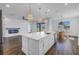 Open concept kitchen with center island, stainless steel appliances, view of fireplace and dining nook at 10934 Sundrift Dr, Tampa, FL 33647