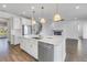 Beautiful kitchen with center island, stainless steel dishwasher, and view to staircase and fireplace at 10934 Sundrift Dr, Tampa, FL 33647