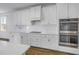 Bright, modern kitchen with white cabinets, stainless steel appliances and designer hardware at 10934 Sundrift Dr, Tampa, FL 33647