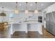 Bright kitchen with white cabinets, center island with pendant lighting and stainless steel appliances at 10934 Sundrift Dr, Tampa, FL 33647