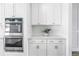 Kitchen with large center island, stainless steel dishwasher and wood flooring and view of fireplace at 10934 Sundrift Dr, Tampa, FL 33647