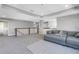 A spacious living area with a sectional couch and access to multiple rooms at 10934 Sundrift Dr, Tampa, FL 33647