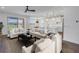 Open concept living room, kitchen and dining nook with plenty of natural light and stylish furnishings at 10934 Sundrift Dr, Tampa, FL 33647