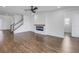 An open-concept living room featuring hardwood floors, a modern fireplace, and natural light at 10934 Sundrift Dr, Tampa, FL 33647