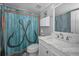 Stylish bathroom featuring a unique shower curtain and a marble countertop vanity at 1264 N Florida Ave, Tarpon Springs, FL 34689