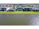 Beautiful lake view homes featuring screened-in pools and lush green lawns at 12851 Tortoise Shell Pl, Riverview, FL 33579