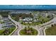 Aerial of community amenities, pool and clubhouse surrounded by lush greenery and a scenic lake view at 12851 Tortoise Shell Pl, Riverview, FL 33579