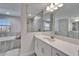 Bright bathroom featuring a shower, tub, double vanity with white cabinets, and lots of natural light at 12851 Tortoise Shell Pl, Riverview, FL 33579