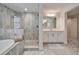 Modern bathroom with glass-enclosed shower, a tub, and dual sink vanity at 12851 Tortoise Shell Pl, Riverview, FL 33579