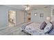 Bedroom with carpeted floors, bright walls, a ceiling fan and view into the adjacent bathroom at 12851 Tortoise Shell Pl, Riverview, FL 33579