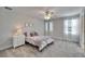 Bedroom featuring carpeted floors, bright walls, a ceiling fan and two large windows at 12851 Tortoise Shell Pl, Riverview, FL 33579