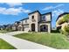 Stunning two-story home boasts stone accents, a well-manicured lawn, and great curb appeal at 12851 Tortoise Shell Pl, Riverview, FL 33579
