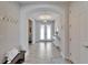 A bright foyer featuring a bench and a view into other rooms through an arched entryway at 12851 Tortoise Shell Pl, Riverview, FL 33579